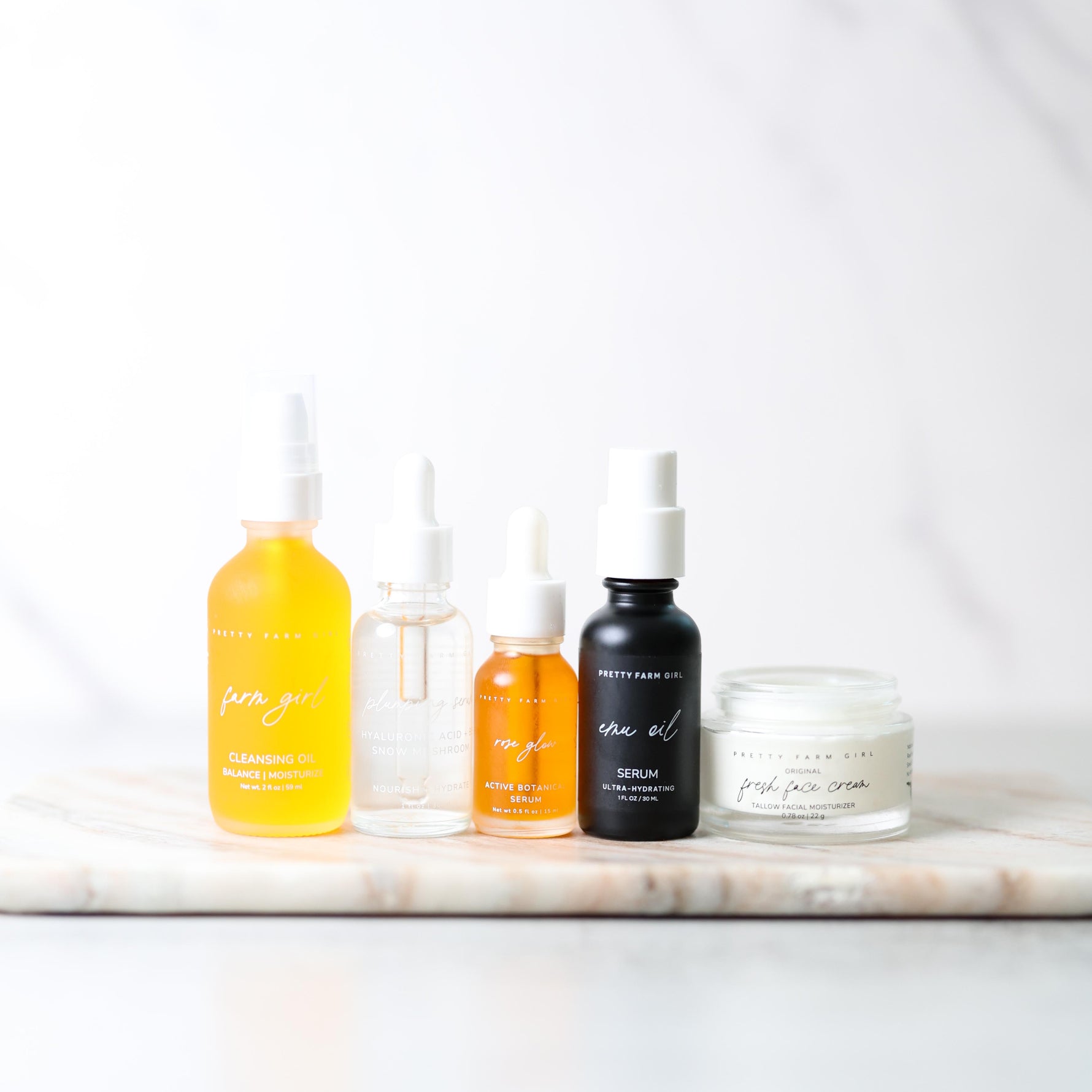 Set of skincare products on a marble surface with a white background