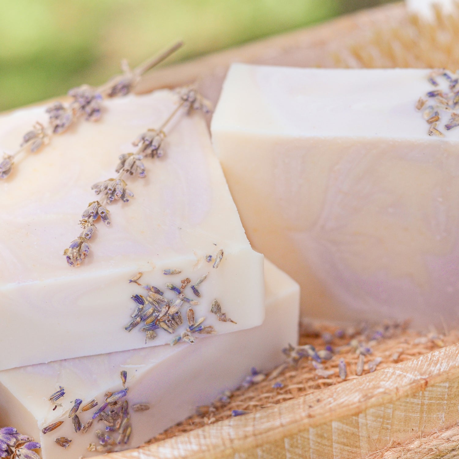 Lavender + Mint Soap Bar pieces with lavender on a natural surface