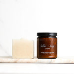Jar of 'Tallow + Honey Cream' and neutral colored soap from Pretty Farm Girl on a white background